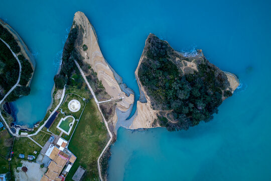 Top down bird's-eye aerial view of the famous Canal d'Amour water channel and sandstone cliffs in Sidari, Corfu, Greece. Spectacular drone perspective of the romantic Mediterranean coastline