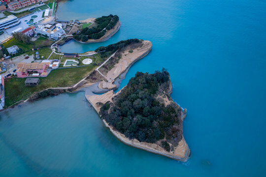 High angle aerial view of the Canal d'Amour peninsula in Sidari, Corfu, Greece. Spectacular coastal landscape featuring eroded sandstone cliffs, lush green vegetation, and calm turquoise sea