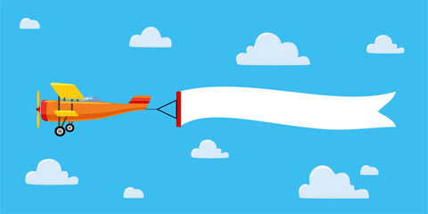 A red airplane in a cloudy sky with a white banner or ribbon for your text, congratulations, company name, or greeting © Svetlana