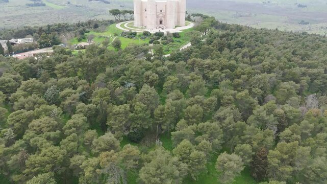 Aerial shot slowly revealing the mysterious castle on the hill in Apulia - Castle del Monte, called one of the most fascinating castles in Italy.