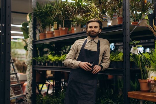 Male small business owner working in plant shop