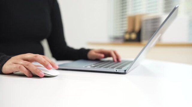Female use keyboard Laptop printing for mobile payments, online shopping on the desk in the morning.