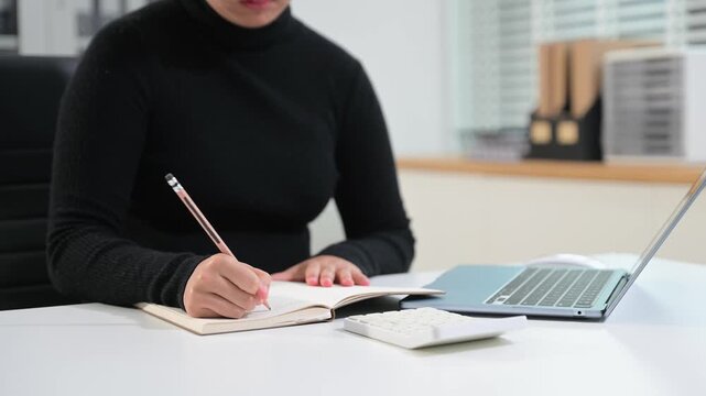 businessman hand working with new modern computer and writing on the notepad strategy diagram
