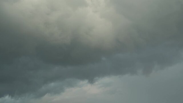 Dark dramatic clouds before a storm. A sky where rain is gradually gathering. The anticipation of a motionless thunderstorm. An abstract background on the theme of bad news.