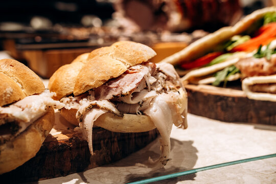 Close-Up Roast Pork Sandwich On Crusty Roll With Sliced Porchetta For Lunch Or Street Food
