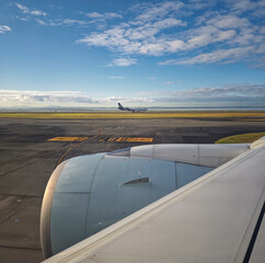 Obraz premium Air New Zealan Boeing 777-300 airplane waiting on runway at airport Auckland International with jet engine in front