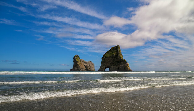 Wharariki beach archway islands and tasman sea waves, new zealand