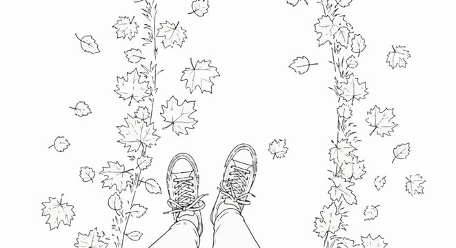 Pair of feet in sneakers standing on a path covered with fallen leaves