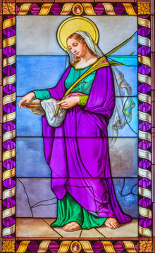 MONZA, ITALY - MARCH 19, 2026:  The St. Agata in stained glass in the church Chiesa di Santa Maria al Carrobiolo by Battista da Saronno from 16. cent. 