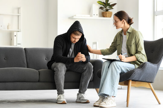 Female psychologist supporting man with suicidal thoughts in office