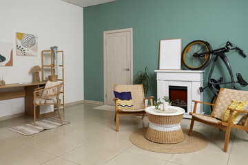 Obraz premium Interior of living room with bicycle, fireplace and armchairs