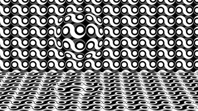 Shapes and patterns move in black and white with repeating designs on a flat surface