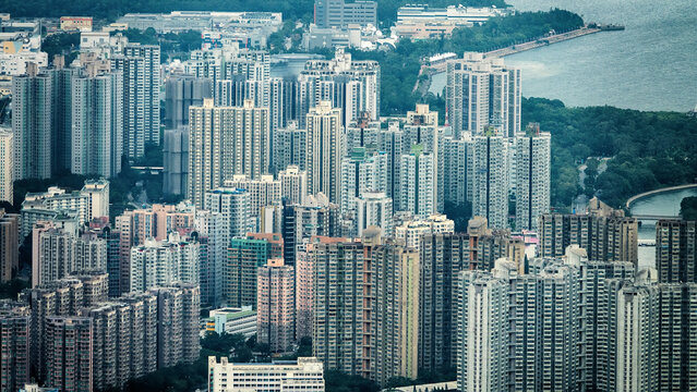 Sea gate. Hong Kong as a major port and residential areas with high-rise apartment buildings. View of the city from Victoria Harbor.