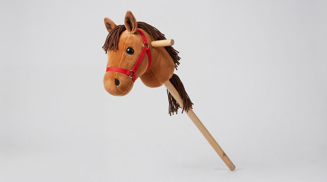 Brown plush hobby horse on wooden stick isolated on white