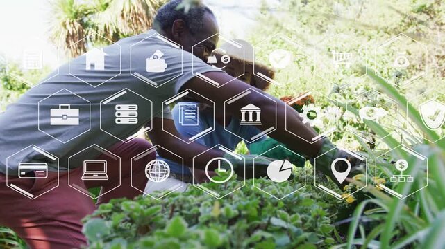 Woman holding potted plant, man leaning in, starting planting into bed while hexagonal icons fading