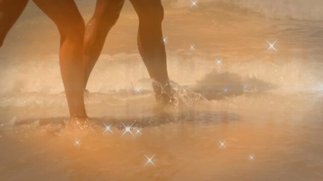 Pair walking surf for leisure, wave nudging steps, leaving prints, sparkle around legs for business