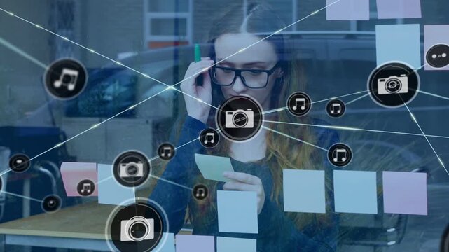 Woman with marker reading notes on glass UI icon appearing creating camera music overlay marketing