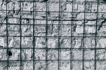 Rough concrete wall surface with metal grid texture © reddish