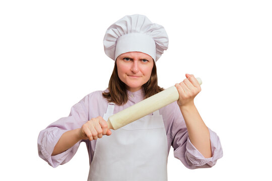 Angry woman baker holding wooden rolling pin. Annoyed cook wearing chef hat and apron. Aggressive culinary professional demonstrating cooking equipment. Kitchen staff during baking preparation.