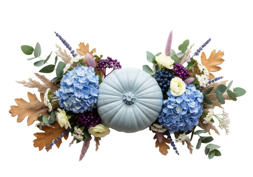 Muted blue-grey pumpkin, framed by blue hydrangeas, deep purple berries, and dried autumnal foliage on a white background. Modern autumnal elegance concept