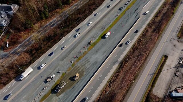 Trans-Canada Highway Construction, With Heavy Machinery And Crews Working On Median. Road Widening Project. aerial topdown, tlt-up shot