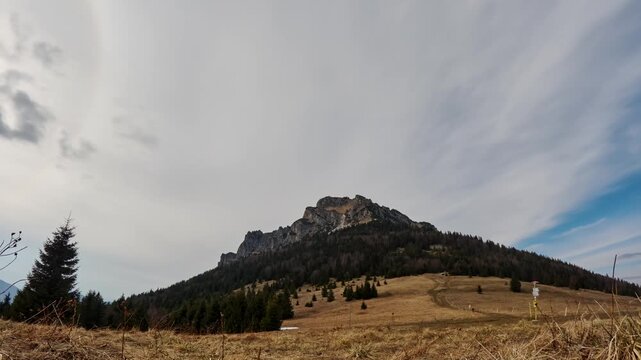 Majestic Rocky Mountain Peak Under Moving Cirrus Clouds in spring Landscape