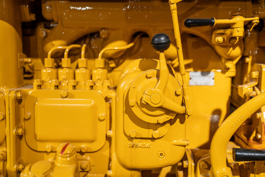 Close-Up of Vintage Tractor Engine in Yellow Industrial Detail