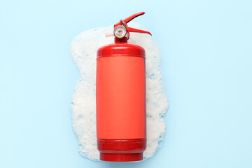 Fire extinguisher with foam on blue background