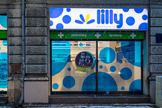 Popular Lilly pharmacy beauty store window exterior during night with night light on Belgrade city street