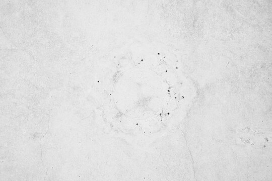 light gray concrete surface with small dark spots