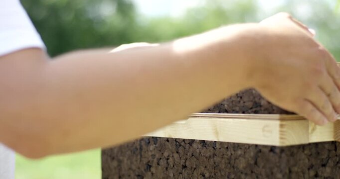 Close up of a modern sustainable beehive made of cork and wood with natural insulation