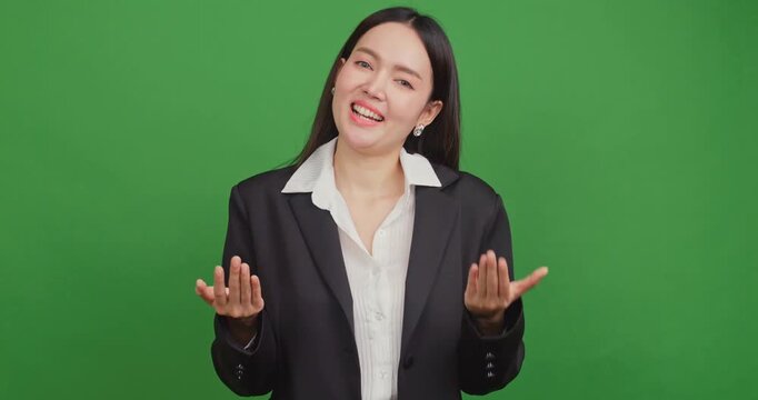 Professional Asian businesswoman talking and gesturing on green screen background for presentation.	