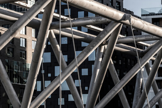 Modern architecture structure with steel truss lattice and diagonal facade in urban setting delivering bold industrial graphic detail