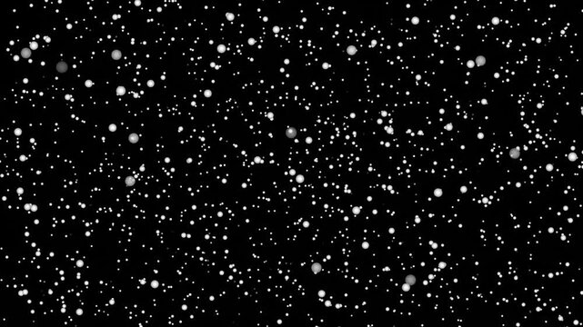 motion footage of white spark particles floating on dark background
