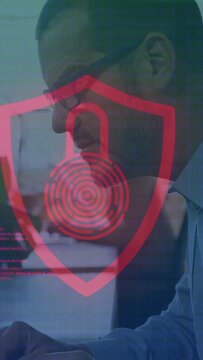 Vertical video: IT pro typing while checking shield lock overlay shifting green red magenta code