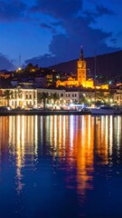Obraz premium A serene waterfront cityscape at dusk with warm lights