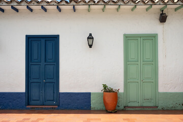 Colorful Colonial Facade With Blue And Green Doors © Bisual Photo