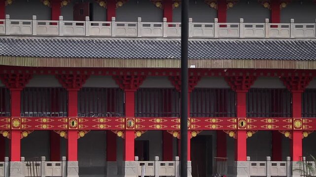 Dibrugarh, Assam, India &ndash; 12 April 2026: Close-up view of a traditional style building facade featuring red pillars, ornate decorative patterns, and detailed architectural elements.