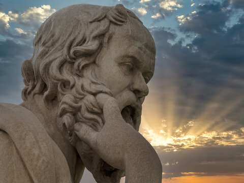 Bust statue of Socrates in Athens captures profound reflection against a luminous sky, honoring the master of Socratic method and truth-seeking.
