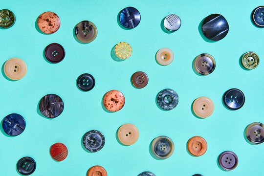 Colorful sewing buttons on bright blue background