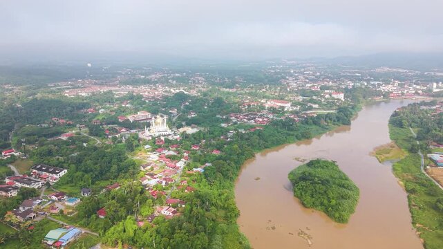 Aerial view of Kuala Kangsar with Ubudiah Mosque and Sungai Perak River in Malaysia. The scenic landscape combines historic architecture, a winding river, and lush urban surroundings. UHD.