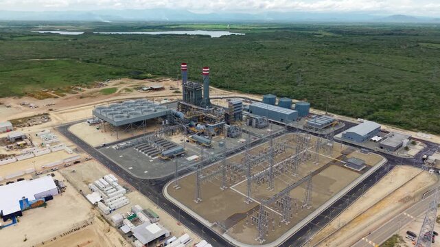 Aerial view of Manzanillo thermoelectric power plant in Montecristi Dominican Republic showing industrial energy infrastructure with turbines substation and transmission systems.