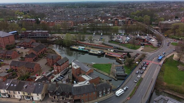 Moored tugboats on River Foss in York, calm urban setting, aerial view