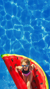 Child in swimming pool. Having fun on vacation at the hotel pool. Colorful vacation concept.