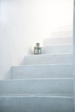 Minimal white stairs with soft light and lantern clean aesthetic background