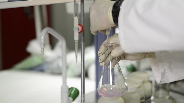 Scientist conducting titration experiment in a laboratory