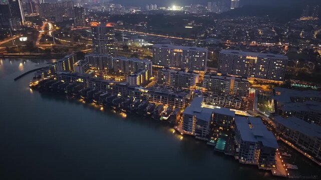 Drone aerial of waterfront residential complex at dusk in Penang, Malaysia.