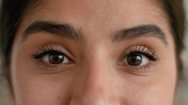 Female portrait close up Indian Arabian woman at home looking at camera eyes gaze vision eyesight healthy pretty attractive young lady face headshot cosmetic natural make-up health medicine indoors