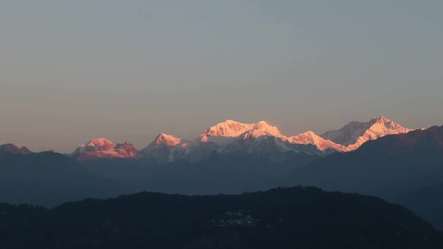 This image appears to be a photograph of Mount Kanchenjunga in the Himalayas at sunrise.
