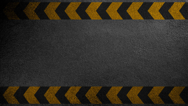 A high-angle view of a grainy black asphalt texture framed by yellow and black chevron caution patterns. Ideal for industrial, safety, or construction themed designs and backgrounds